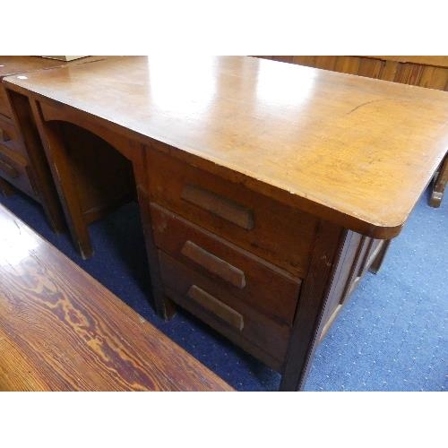 328 - A vintage pitch pine double-sided industrial Partner's Desk, 51in (129.5cm) wide.