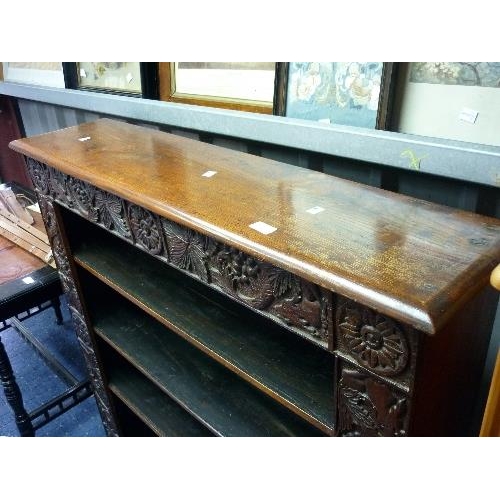 398 - An early 20th century carved oak Open Bookcase, with three adjustable shelves, 43½in (110.5cm) wide.