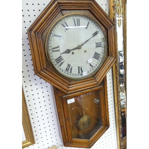 16 - An Edwardian drop dial Wall Clock, the circular dial within an oak octagonal frame, with an eight-da... 