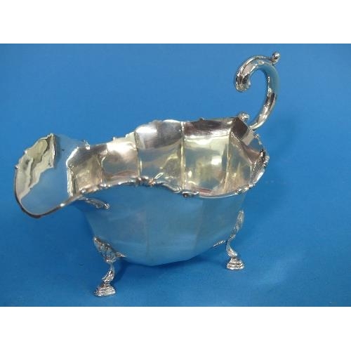 63 - A George V silver Sauce Boat, hallmarked London, 1929, of traditional form with scroll handle, shell... 