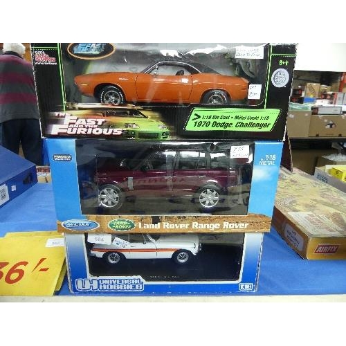 664 - Three 1:18 scale diecast metal model Cars, all boxed, comprising Universal Hobbies MGB GT Police Car... 