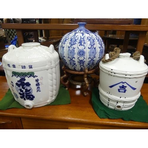 104 - A 20thC Chinese blue and white porcelain gourd-shaped Vase and Cover, 11½in (29cm) high, on an openw... 