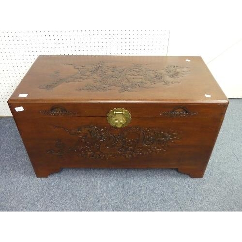 108 - A 20thC oriental carved camphor wood Chest, with engravings depicting dragons, width 40in x depth 19... 