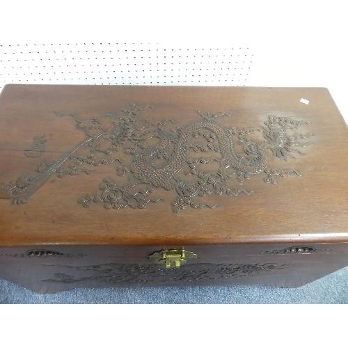 108 - A 20thC oriental carved camphor wood Chest, with engravings depicting dragons, width 40in x depth 19... 