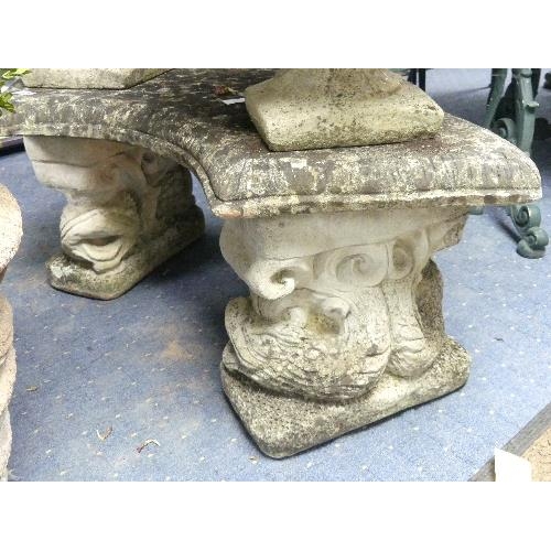 11 - Garden statuary: a reconstituted stone curved garden seat raised on porpoise supports, 43in (110cm) ... 