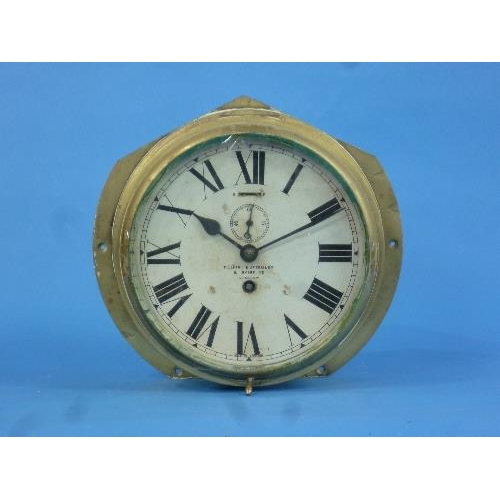 475 - A brass bulkhead wall Clock, by Kelvin, Bottomley & Baird Ltd, Glasgow, the 8in (20.25cm) circular d... 