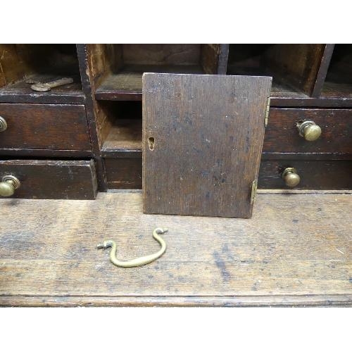 491 - A small Georgian oak Bureau, the fall front with fitted interior, above three long drawers, bracket ... 