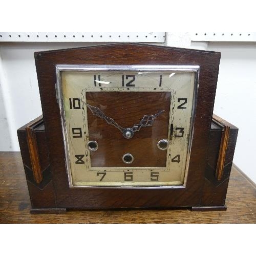 504 - A 1920's Art Deco style 8-day chiming Mantel Clock, the oak case of angular architectural form with ... 