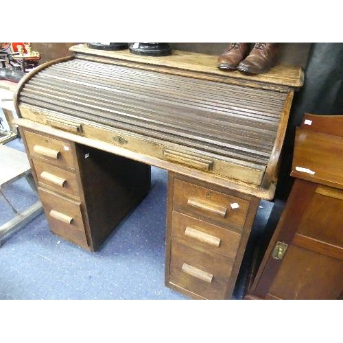 121 - An early 20thC oak Roll-top Desk, named 'The Ebus Desk', comprising fitted compartments on six drawe... 