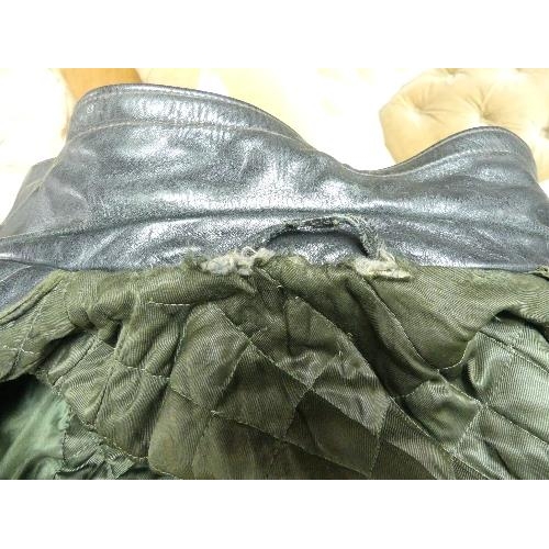 29 - A WWII period black leather German Overcoat,  with quilted and padded green satin lining, frayed at ... 