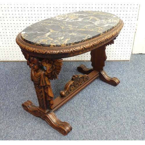 449 - An ealry 20thC marble-topped walnut Table, on carved legs with cherub decoration, width 29in x depth... 