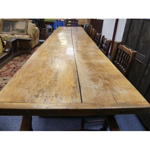 477 - A large Refectory Dining Table, the two-plank top with cleated ends, the base on supports and sledge... 