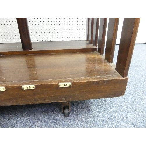 478 - An early 20th century oak revolving Bookcase, fitted with a folding book-stand, the rectangular top ... 