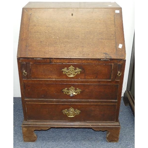 491 - A small Georgian oak Bureau, the fall front with fitted interior, above three long drawers, bracket ... 