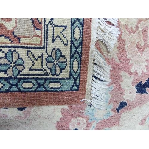 495 - Tribal Rugs; a large hand knotted Bakshaish style rug, the light coral-coloured ground with large st... 