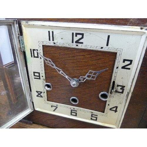 504 - A 1920's Art Deco style 8-day chiming Mantel Clock, the oak case of angular architectural form with ... 