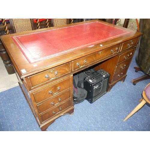 76 - A reproduction mahogany Pedestal Desk, with red leatherette inset and six drawers, width 54in x dept... 