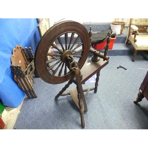 102 - A vintage oak Spinning Wheel, 34in (86.5cm) long, 22in (56cm) wide, 39in (99cm) high.