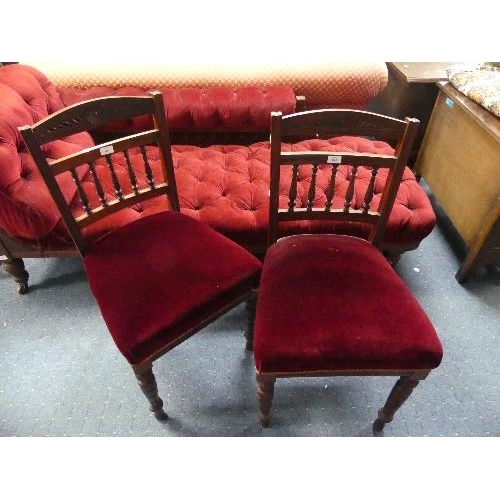 104 - A Late Victorian mahogany-framed Chaise Longue, button-back with red upholstery, raised on turned le... 