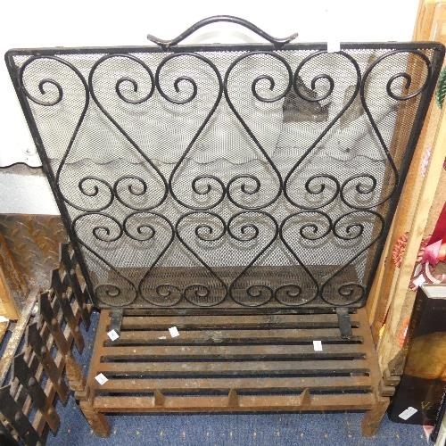 107 - A wrought iron Spark Guard, 24in (61cm) wide x 26in (66cm) high, together with an antique cast iron ... 