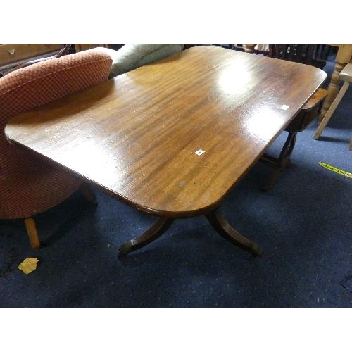 121 - A reproduction mahogany rectangular tilt-top Breakfast Table, with turned and fluted column, leaf ca... 