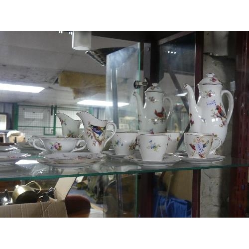 123 - A Royal Doulton exotic bird pattern part Tea Service, comprising four cups, six saucers, cream jug, ... 