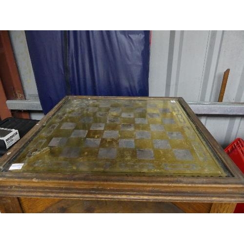 226B - An early 20thC oak Games Table, the square top with brass effect chess board, raised on barley twist... 