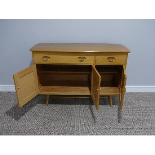 3 - A mid 20thC Ercol light elm and beech Sideboard, Model 351, with a long drawer above a double cupboa... 