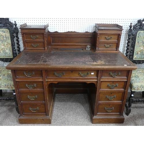 71 - An Edwardian walnut twin Pedestal Desk, by Maple & Co. Ltd., with raised back and tooled leather ski... 