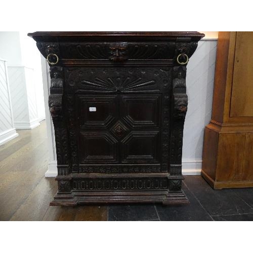 74 - A Victorian Jacobean style carved oak upright Cabinet, with moulded cornice, single leaded glass pan... 