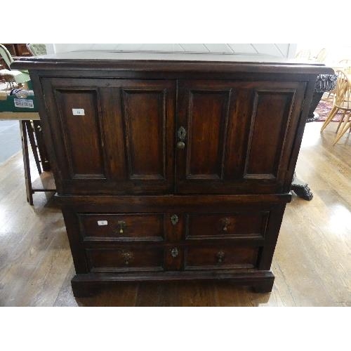 78 - A 19th century oak Carolean style Panelled Chest, with two cupboard doors above two long drawers on ... 