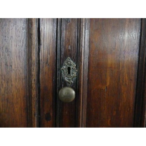 78 - A 19th century oak Carolean style Panelled Chest, with two cupboard doors above two long drawers on ... 