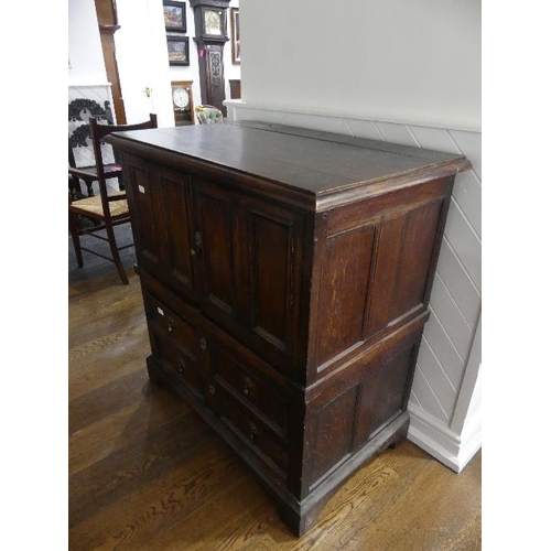 78 - A 19th century oak Carolean style Panelled Chest, with two cupboard doors above two long drawers on ... 