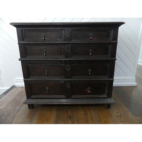 80 - An 18th century oak Panelled Chest, of two short and three long drawers, on block feet, 37½in (95cm)... 