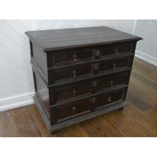 80 - An 18th century oak Panelled Chest, of two short and three long drawers, on block feet, 37½in (95cm)... 