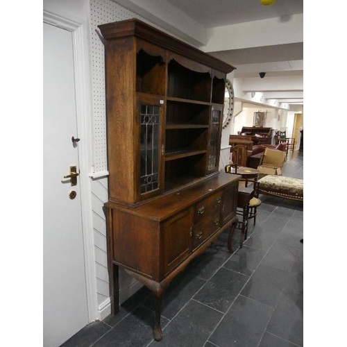 81 - An early 20th century Oak Dresser, with leaded glass panel doors, 60in (152.5cm) wide x 79in (200.5c... 