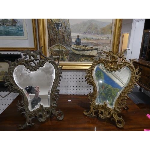 83 - A pair of early 20th century gilt metal Easel Mirrors, with bevelled edged plates, each of foliate s... 