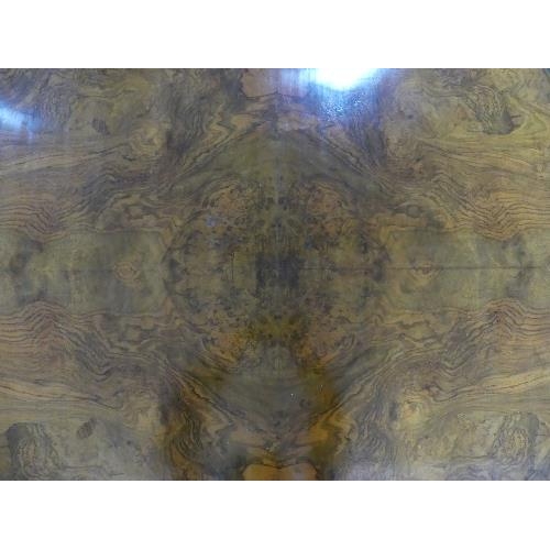 84 - A Victorian walnut oval Breakfast Table, quarter veneered top above a deep frieze, turned quatre-col... 