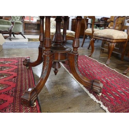 84 - A Victorian walnut oval Breakfast Table, quarter veneered top above a deep frieze, turned quatre-col... 