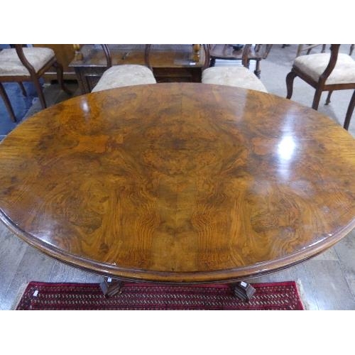 84 - A Victorian walnut oval Breakfast Table, quarter veneered top above a deep frieze, turned quatre-col... 