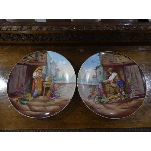 87 - A pair of early 20th century French porcelain Wall Plates, printed and painted with figures and buil... 