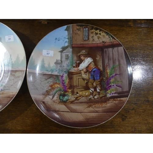 87 - A pair of early 20th century French porcelain Wall Plates, printed and painted with figures and buil... 