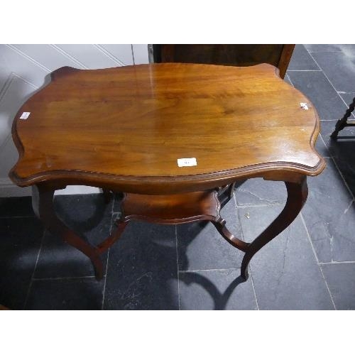 97 - An Edwardian mahogany two tier Occasional Table, with shaped rectangular top, 29½in wide x 17½in dee... 