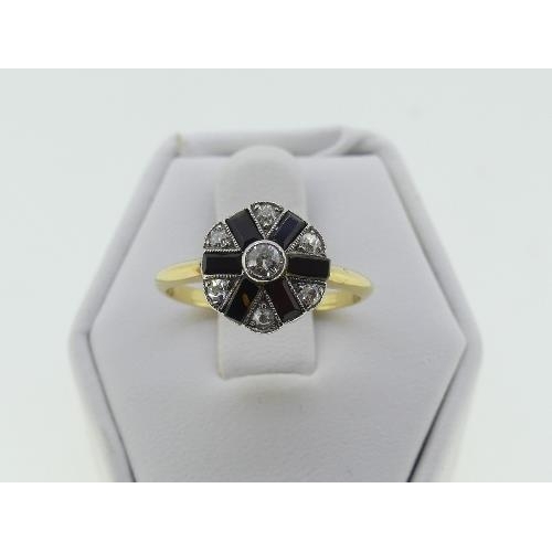 121 - An Art Deco diamond and black onyx Cluster Ring, the central diamond surrounded by six smaller, all ... 