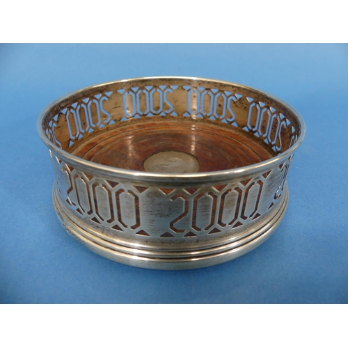 106 - A commemorative Millennium silver Bottle Coaster, by W I Broadway & Co., hallmarked Birmingham, 2000... 