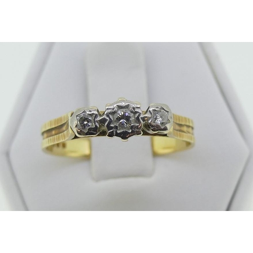 112 - A three stone diamond Ring, the graduated stones illusion set in 18ct yellow and white gold, Size S,... 