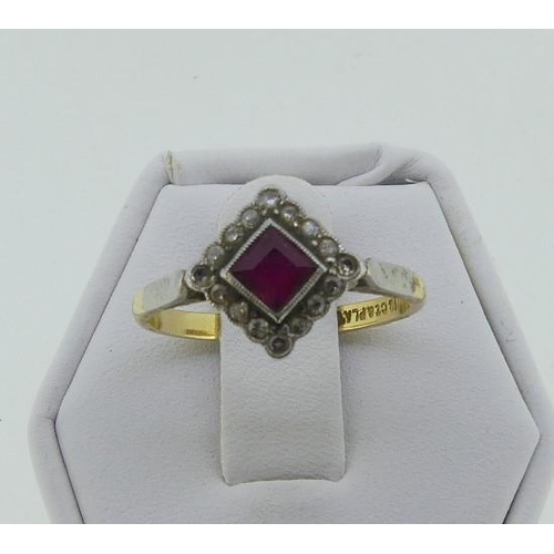 116 - An Art Deco ruby and diamond Dress Ring, the central square cut ruby within a border of sixteen smal... 