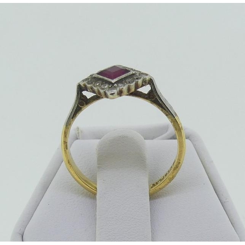 116 - An Art Deco ruby and diamond Dress Ring, the central square cut ruby within a border of sixteen smal... 