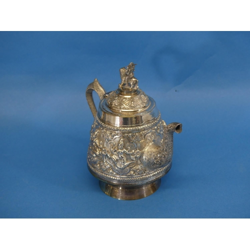 61 - An Indian silver three piece Tea Set, of circular form with scroll handles, the teapot with finial d... 