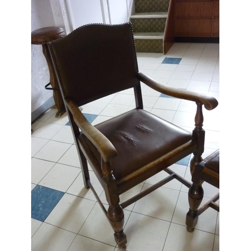 620 - A set of seven early 20thC oak Dining Chairs, with studded leather upholstery, including one carver ... 